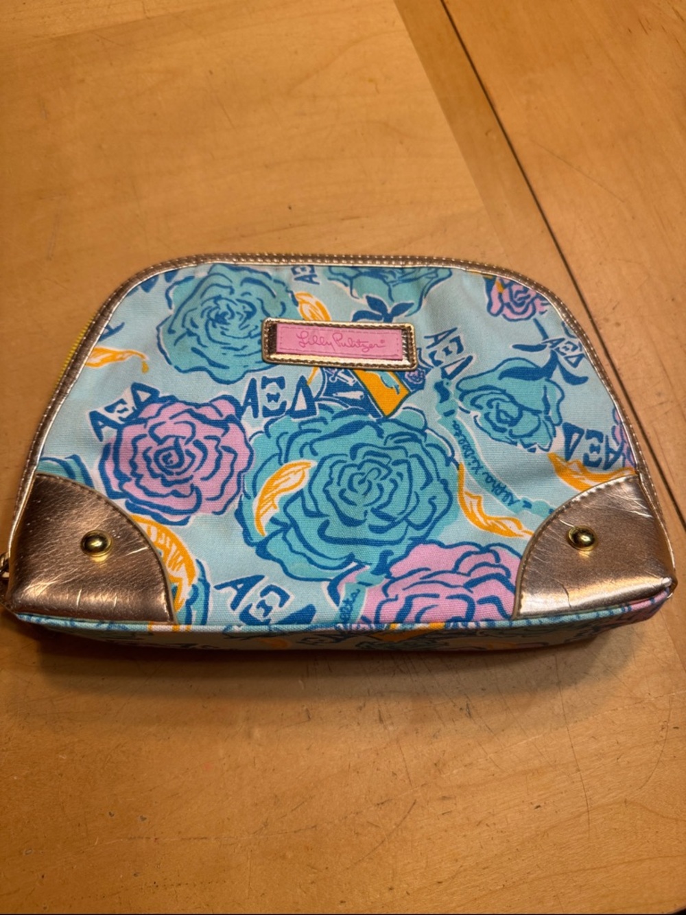 Estée Lauder Lilly Pulitzer blue floral makeup pouch with pink logo, gold trim